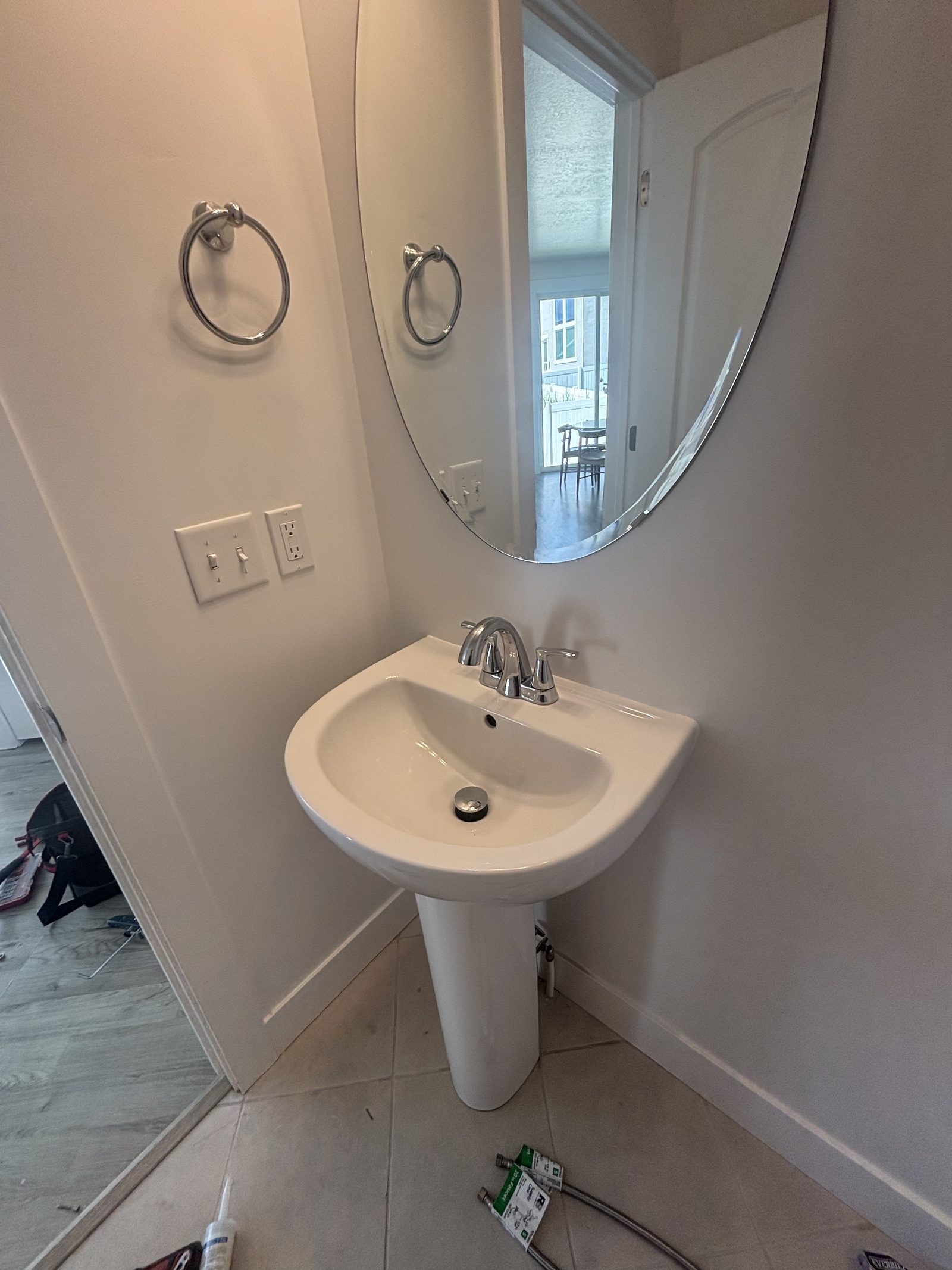Finished pedestal sink and fixture install by Handy Pro Utah